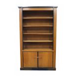 Haagse StijlAn oak and ebonised wooden bookcase, the lower part with two cupboard doors, in the