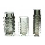 SeventiesThree green and clear glass rectangular section mould blown vases with relief pattern of