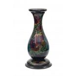 Plateelbakkerij Zuid Holland, GoudaA ceramic pedestal decorated with floral pattern on a black