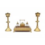 Arts & CraftsAn oak, glass and brass inkwell with matching pair of bronze candlesticks, the torded