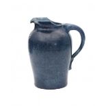 Willem Coenraad Brouwer (1877-1933)A ceramic blue glazed pitcher with incised flower-shaped