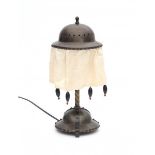 Amsterdamse SchoolA patinated brass table lamp, the openworked and engraved shade with new fabric,