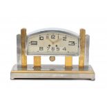 Art DecoA partly chromium plated brass mantle clock, the bent rectangular dial with Art Deco