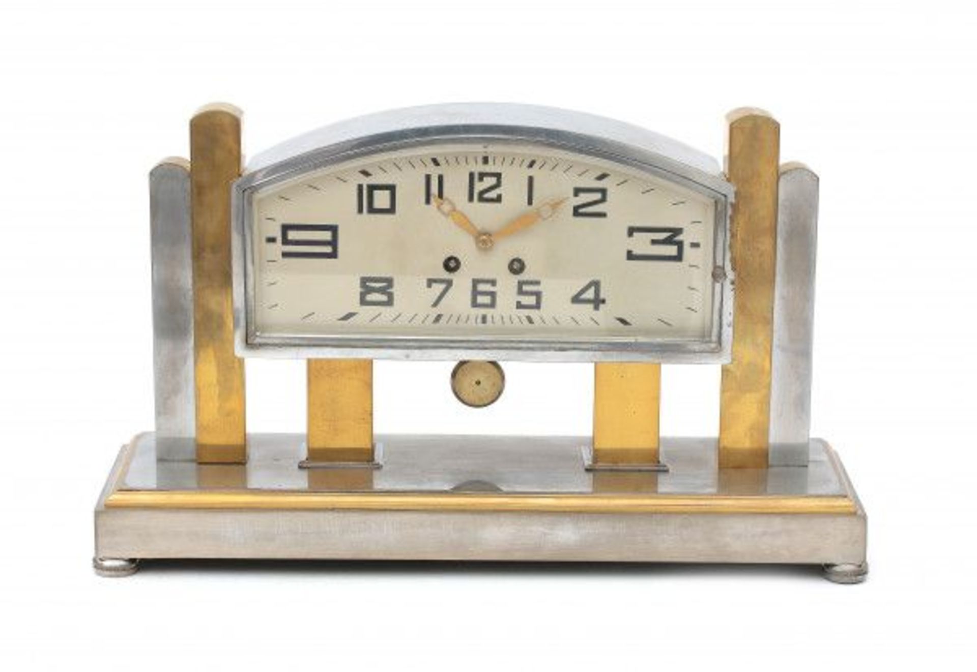 Art DecoA partly chromium plated brass mantle clock, the bent rectangular dial with Art Deco