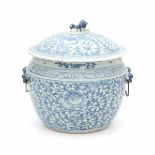 A Chinese blue and white lidded jar, with a scrolling floral pattern. The cover with a foo dog