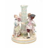 A base of a porcelain centerpiece, a group of dancers around a palm tree. Marked with crossed