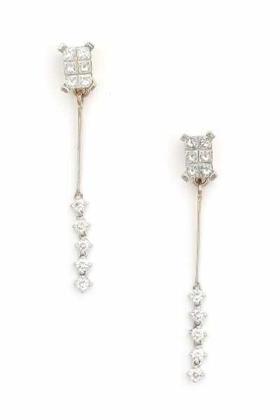 A pair of white gold earrings, made ca. 1970's - 1980's. Set with princess and brilliant cut