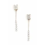 A pair of white gold earrings, made ca. 1970's - 1980's. Set with princess and brilliant cut