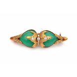 A yellow gold brooch made in the 1960's - 1970's, set with two fancy cabochon cut chrysoprases,