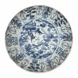 A Chinese blue and white charger, decorated with ducks on the waters edge with lilies. Late Ming