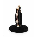 14 carat yellow gold art deco bracelet set with cultured pearls and natural carré cut rubies.