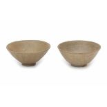 Two light brown glazed bowls, one modelled with lotus petals, the other with an incised floral