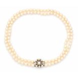 A double strand pearl necklace with 14 carat white gold diamond set clasp. Pearls are light