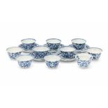 A set of ten Chinese cups and five saucers, decorated with a pattern of birds and flowers. With