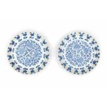 A pair of Chinese blue and white plates, decorated with peonies. Marked with an apocryphal