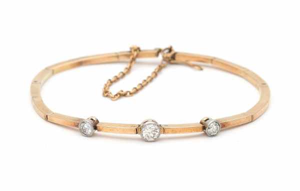 14 carat pink gold hinged bracelet, from early 20th century. Set with three old-European cut