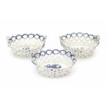 Three English blue and white softpaste baskets, decorated with 'pine cone'pattern. Marked with a