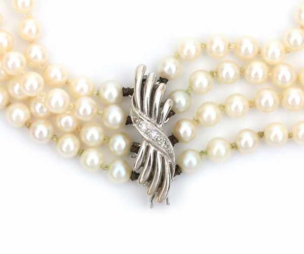 A three strand cultured pearl choker or 'collier du chien' with a 14 carat white gold clasp, set - Image 2 of 2