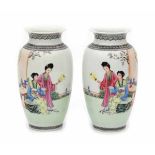 A pair of Chinese famille rose vases, decorated with elegant ladies in a garden. With apocryphal