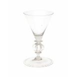 Two baluster wine glasses, one with four lobed stem, the other with an engraving around the rim.