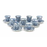 A set of nine Chinese blue and white high cup and saucers, decorated with peonies and lotus in petal