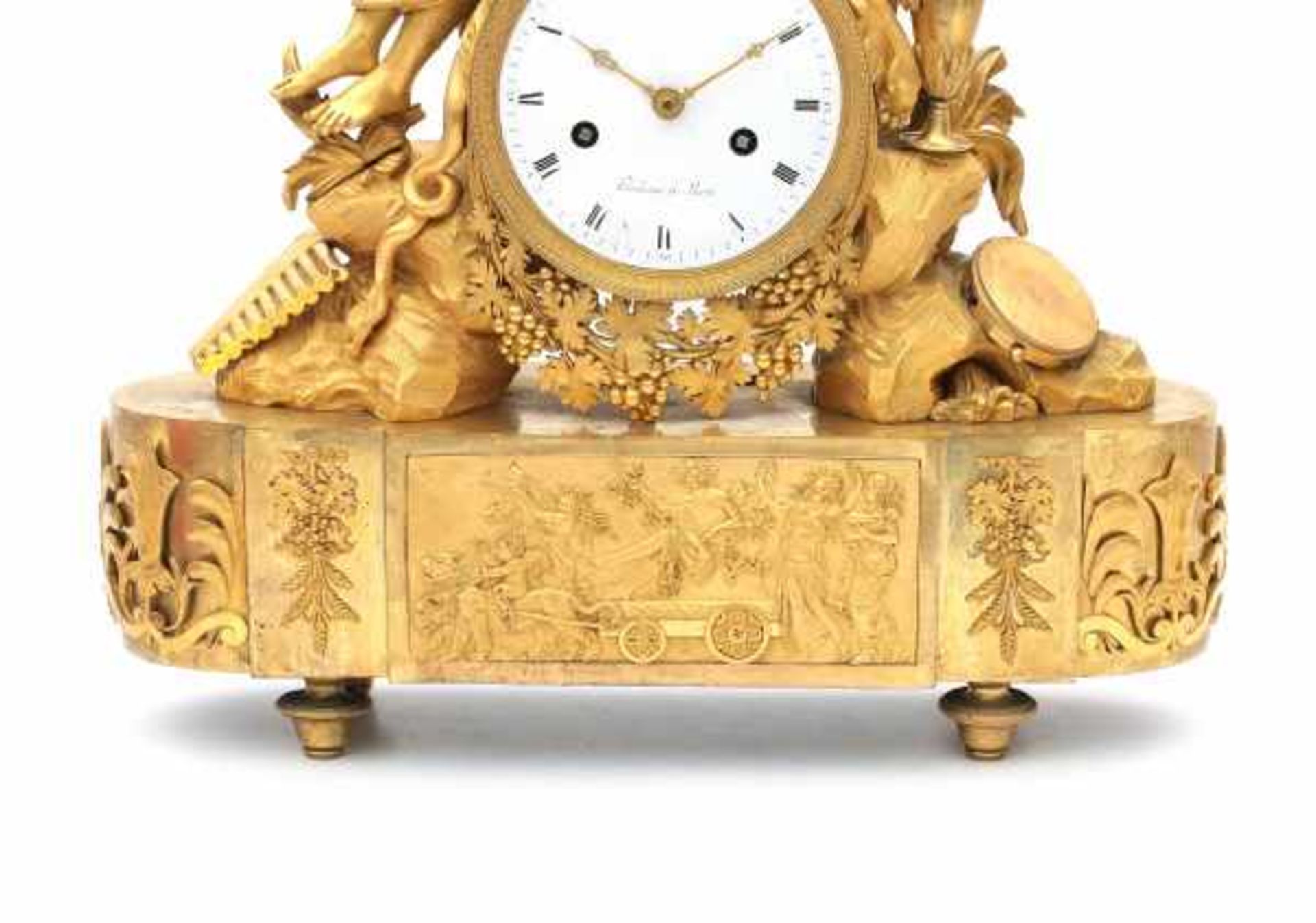 An ormulu mantle clock with a figure of Bacchus. The enamelled dial with roman numerals and adress