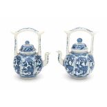 A pair of small Chinese blue and white wine pots, decorated with vines in panels. Kangxi period (