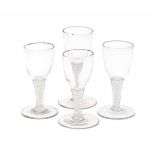A collection of four English 'twist' wine glasses, with white double spiral in the stem. 18th