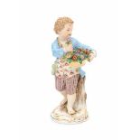 A porcelain figurine, a young man with a flower basket. Marked with crossed swords, Meissen, circa
