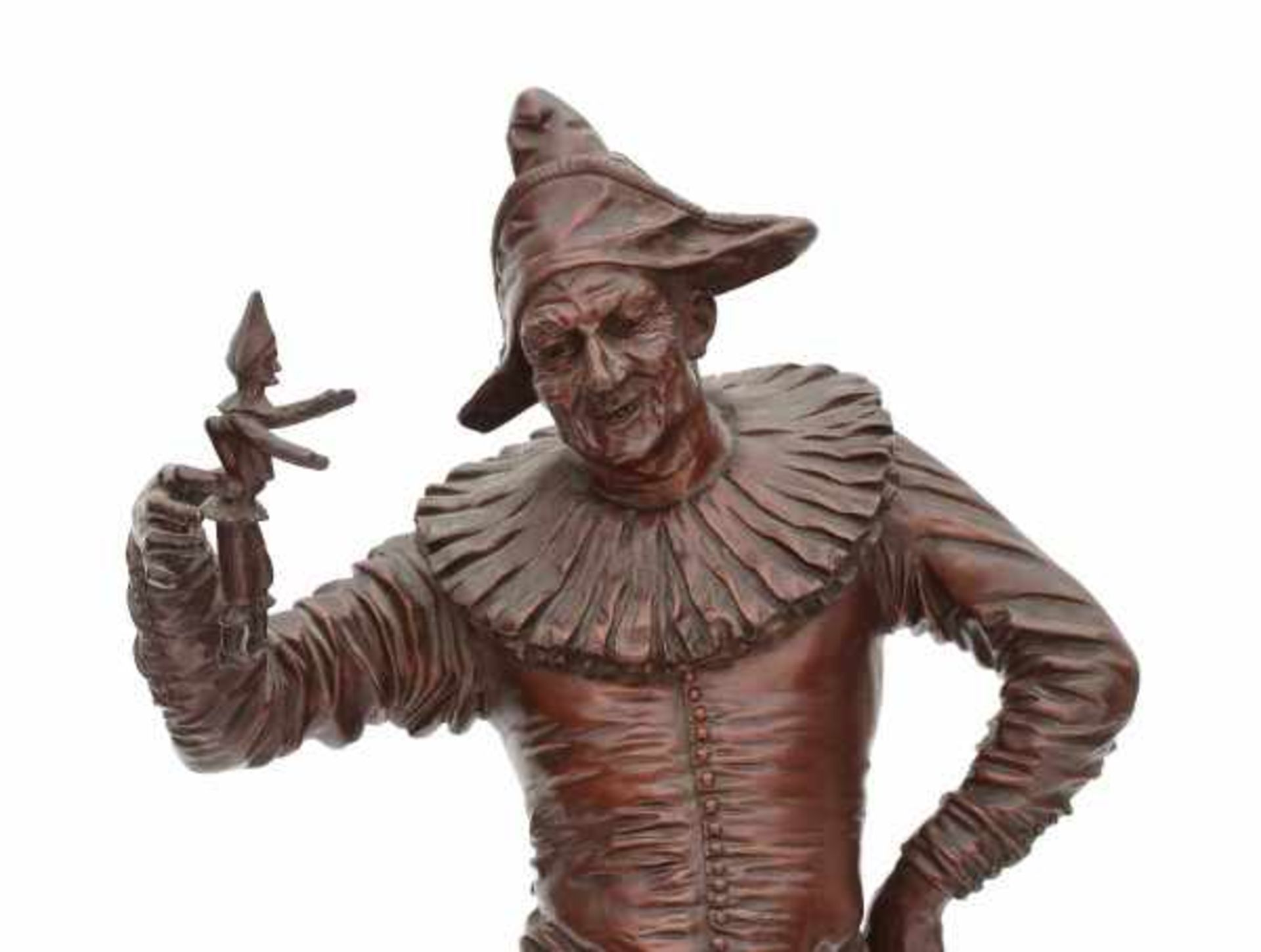 G. Gueyton (XIX)A bronze sculpture, a standing harlequin holding a marionette. Signed on the base.