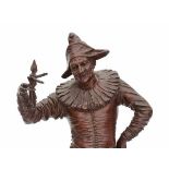 G. Gueyton (XIX)A bronze sculpture, a standing harlequin holding a marionette. Signed on the base.