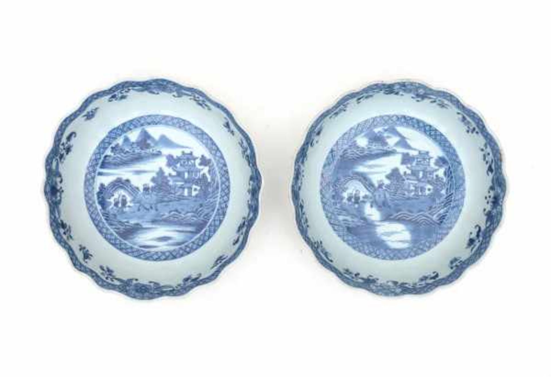 A pair of Chinese blue and white export bowls, decorated with boys playing on the back of an ox in a