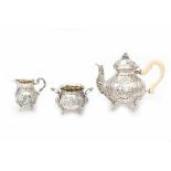 A German three piece silver tea service. Maker's mark Weinranck & Schmidt, Hanau Ca. 1900. Teapot