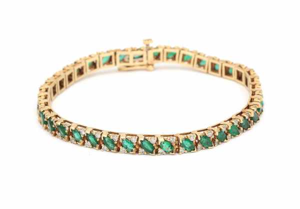 A yellow gold rivera bracelet. set with marquise cut emeralds, total ca. 2.66 ct, and brilliant