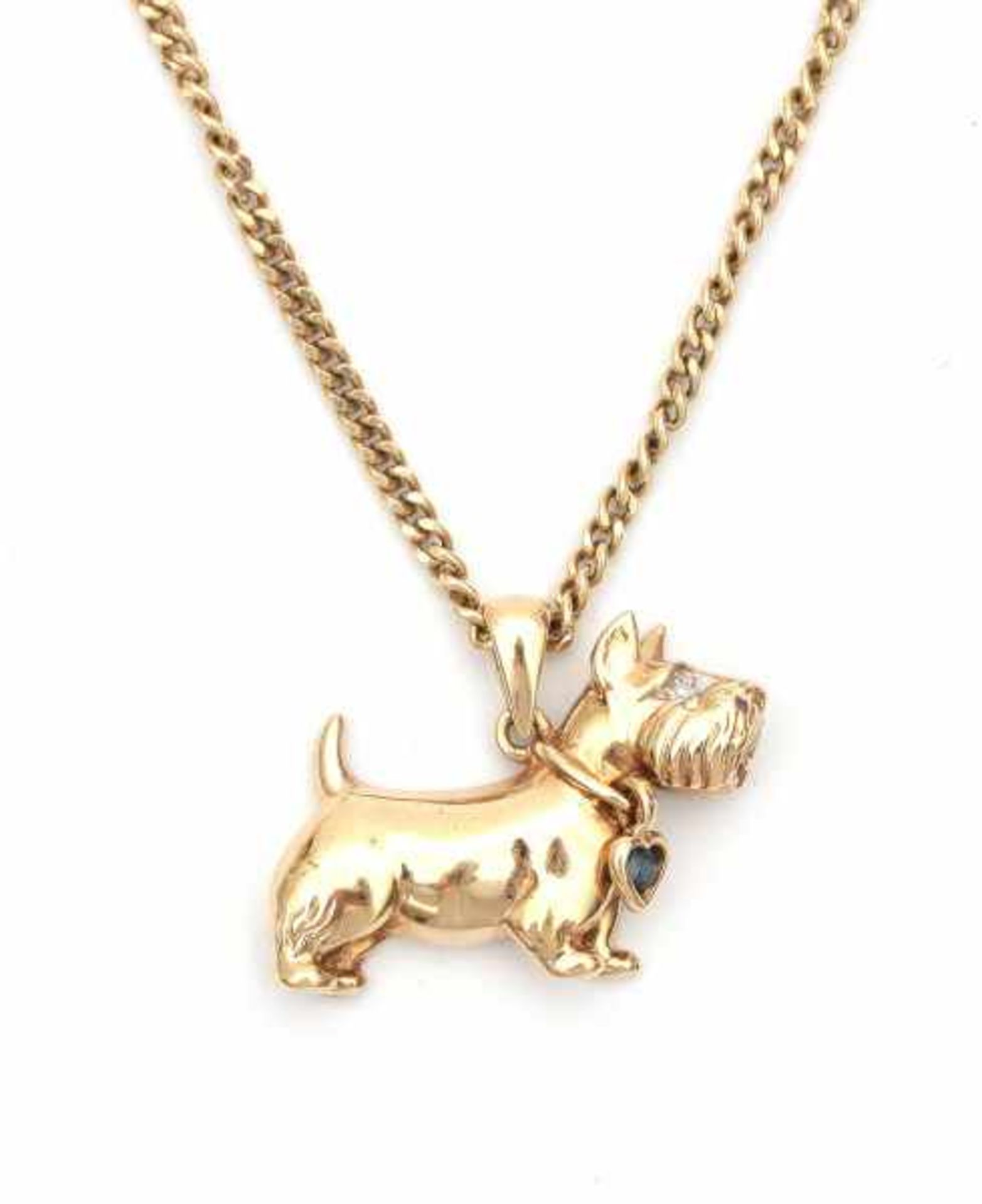 A 14 carat yellow gold pendant shaped like a terrier with necklace. Set with a single cut diamond,