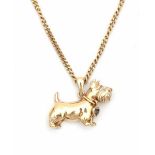 A 14 carat yellow gold pendant shaped like a terrier with necklace. Set with a single cut diamond,