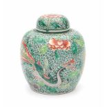 A Chinese famille verte lidded jar, decorated with a phoenix amidst flowering peonies. 19th