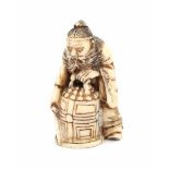 A Japanese ivory netsuke, Shoki capturing an oni under a bell. Signed Yozen. Meiji period (1868-