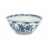 A Chinese blue and white bowl, decorated with a bird on a rock between blossoming flowers. With