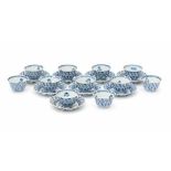 A set of eight blue and white cup and saucers, decorated with flowers. With three extra cups. With