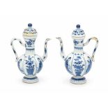 A pair of Chinese blue and white ewers, decorated with long Eliza and flowers in panels. Kangxi