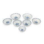 A collection of seven English blue and white baskets in three sizes, decorated in 'pine cone