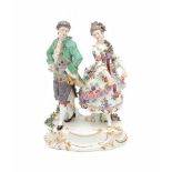 A porcelain group, dancing couple dressed in fine clothes. Marked with crossed swords, Meissen,