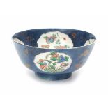 A Chinese powder blue bowl, decorated on the inside and outside with panels of flowers. With lozenge
