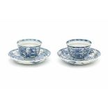 A pair of Chinese blue and white horizontally ribbed cup and saucers, decorated with lotus. With
