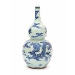 A Chinese blue and white double gourd vase, decorated with dragons and flaming pearl. 19/20th
