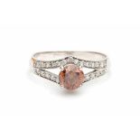 A white gold solitaire ring, set with a brown, brilliant cut diamond of ca. 0.70 ct, ca. Si2-P1