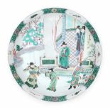 A Chinese famille verte charger, decorated with martial arts practice in a garden, possibly a