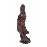 A Chinese carved wooden sculpture, Guanyin dressed in loose robes. 19th centuryheight 34 cm.- - -