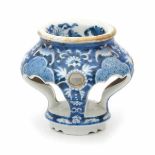 A Chinese blue and white salt cellar, decorated with flowers and bats. The bats and rim